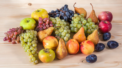 autumnal fruit still life on rustic wooden table background