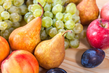 autumnal fruit still life on rustic wooden table background
