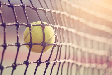 Rolgordijnen Tennis ball hitting the tennis net at tennis court with copy space. © yuthana Choradet