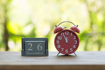 December 26. BOXING DAY.calendar with date on wooden background.Retro alarm clock with five minutes to twelve o'clock. Christmas concept