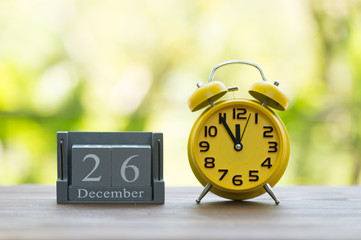 December 26. BOXING DAY.calendar with date on wooden background.Retro alarm clock with five minutes to twelve o'clock. Christmas concept