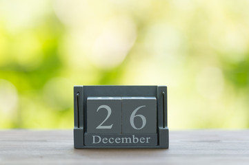 December 26. BOXING DAY.calendar with date on wooden background.Retro alarm clock with five minutes to twelve o'clock. Christmas concept