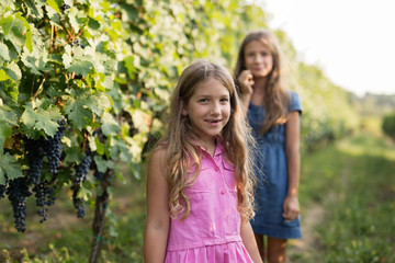 Happy little girls in vineyard