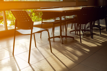 Empty table and chair in canteen with sun light.