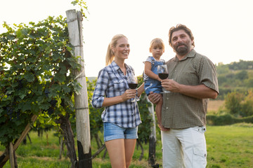 Winegrower family tasting wine