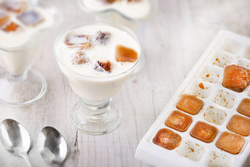 Milk cocktail with ice cubes with a form with a cubes 