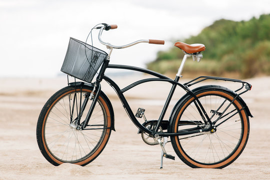 Pretty bicycle parked on beach. Retro bike near the sea