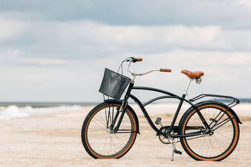 Pretty bicycle parked on beach. Retro bike near the sea