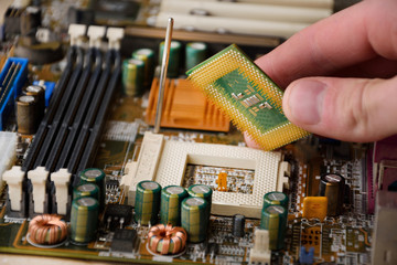 processor in the hands of man, the person puts the processor in place,  the person puts the processor in the socket, the motherboard, the processor, the installation of the processor