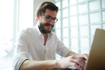 Businessman communicating with colleague or friend through net