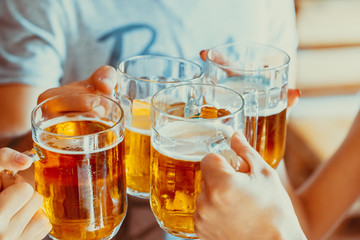 Happy Friends Drinking Beer At Pub, Leisure, Friendship And Celebration Concept. Beautiful Background Of The Oktoberfest. A Group Of Young People While Relaxing At The Bar. Soft Focus. Shallow DOF