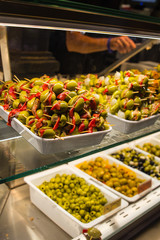 Stuffed olives canape in market