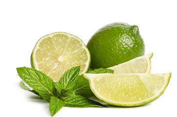 green mint, lime and  two slices of a juicy lime isolated on white background