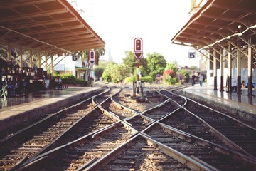 Fototapeta premium Station Train platform tracks leading into the sunset.