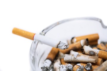 smoking a cigarette on ashtray in white background.
