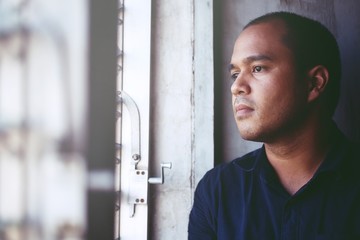  depressed man Absent-minded stand edge the window .dramatic concept