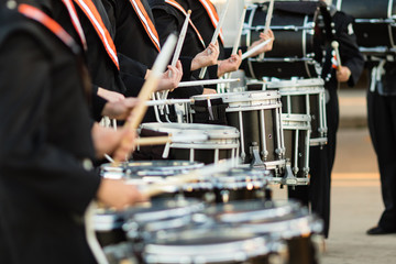 drum sticks flashing as the drumline warms up
