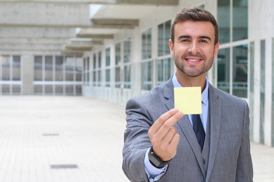Businessman showing a note isolated  