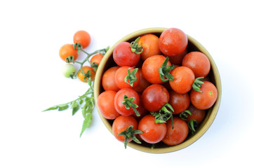 Fresh cherry tomatos vegetable in bowl isolated on white backgrounds above