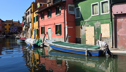 Fototapeta na wymiar Colorful houses boats and canal of Burano Island in the Venetain Lagoon.