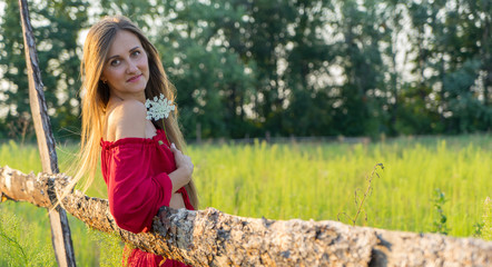 cheerful rural girl in red dress.