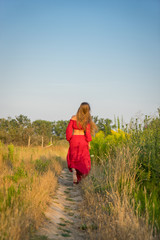 cheerful rural girl in red dress.