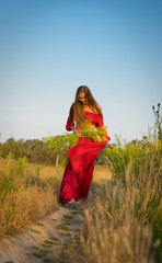 Obraz premium cheerful rural girl in red dress.