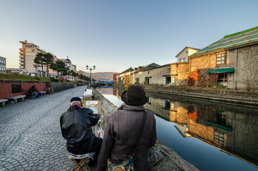 Otaru, Japan- 13 NOV 2015: An old artist painting the infamous Otaru Canal. The Canal was once a...