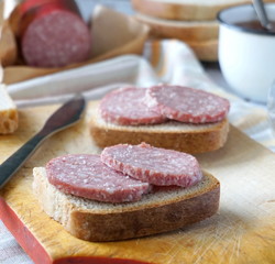 Sandwich with sausage and black tea with sugar