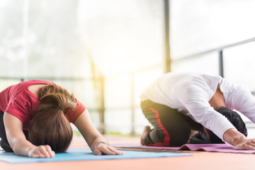 Group of  people doing yoga in the class