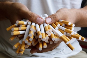Stack Tobacco Cigarettes holding in hand.concept background Cigarette.
