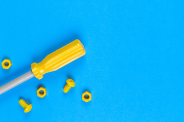 Toys background. Kids construction toys tools on light blue and yellow background.