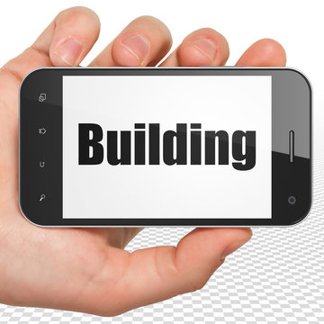 Constructing concept: Hand Holding Smartphone with Building on display