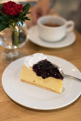 blueberry cheese cake on plate in cafe