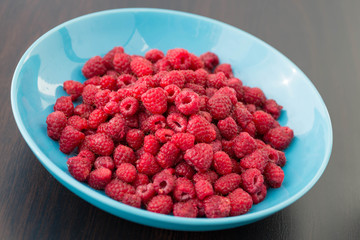Fresh raspberries in a  plate