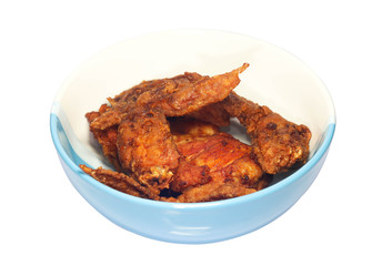 Closeup of fried chicken wings on the white and blue bowl