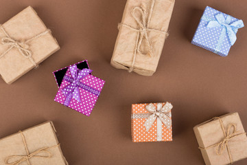 Handmade gift boxes on brown paper background. Top view