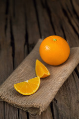 fresh orange and orange slices group on a dark wooden table