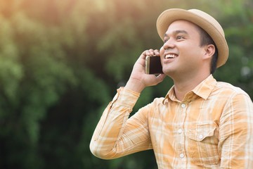 close up of Young Man using telephone good mood. or Business man Contact communicate far way with Customer Happy mood in atmosphere Sunlight in the morning.