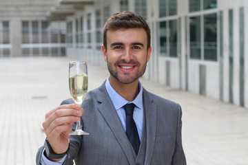 Businessman cheering with champagne glass