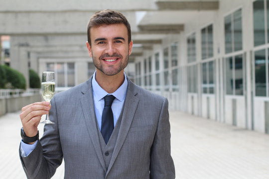 Businessman cheering with champagne glass
