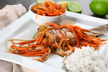 Plate with delicious fish, sauce, rice and vegetables, closeup