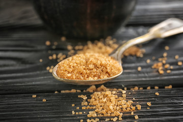 Spoon with cinnamon sugar on wooden table
