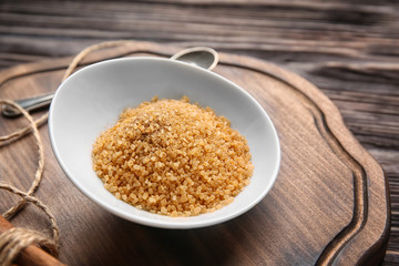 Bowl with cinnamon sugar on wooden board