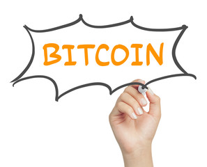 female hand writing bitcoin message in cartoon balloon with marker on transparent board