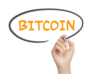 female hand writing bitcoin message in cartoon balloon with marker on transparent board