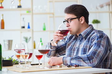 Professional sommelier tasting red wine 