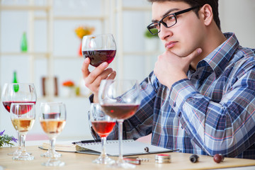 Professional sommelier tasting red wine 