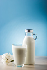 Jar and glass of milk, front view
