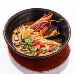 Plate of traditional Thai soup "Tom Yam" with shrimps